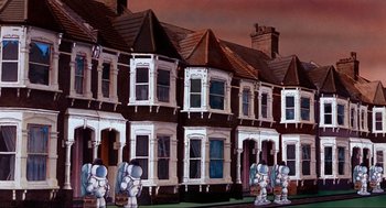 Movie still from “The Meaning of Life” (1983), directed by Terry Jones – A row of houses in a residential neighborhood; Extreme Wide shot, Low angle