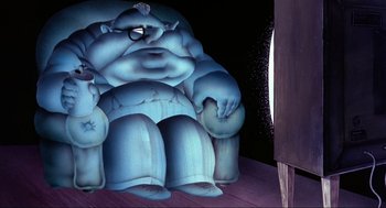 Movie still from “The Meaning of Life” (1983), directed by Terry Jones – An image of an animated character sitting in a chair; Wide shot, Low angle