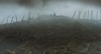 Movie still from “The Meaning of Life” (1983), directed by Terry Jones – A pile of dirt in the middle of a field; Extreme Wide shot, High angle