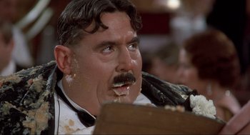 Movie still from “The Meaning of Life” (1983), directed by Terry Jones – A person with a mustache eating food; Close Up shot, Low angle