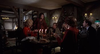 Movie still from “The Meaning of Life” (1983), directed by Terry Jones – A group of people sitting around a dinner table; Medium shot, Over the shoulder angle