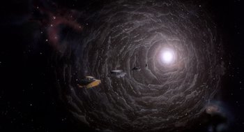 Movie still from “The Meaning of Life” (1983), directed by Terry Jones – An image of a black hole in the sky; Extreme Wide shot, Overhead angle