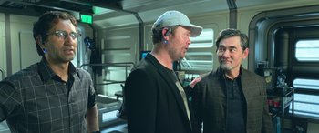 Movie still from “The Meg” (2018), directed by Jon Turteltaub – Two men are talking to each other in a room; Medium shot, Over the shoulder angle