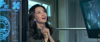 Movie still from “The Meg” (2018), directed by Jon Turteltaub – A beautiful woman with long black wavy hair wearing a black shirt; Close Up shot, Over the shoulder angle