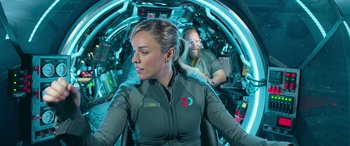 Movie still from “The Meg” (2018), directed by Jon Turteltaub – A woman sitting in a space suit in a space ship; Medium shot, Over the shoulder angle