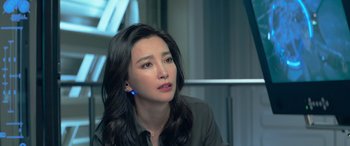 Movie still from “The Meg” (2018), directed by Jon Turteltaub – A woman sitting in front of a window looking off into the distance; Close Up shot, Over the shoulder angle