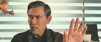 Movie still from “The Meg” (2018), directed by Jon Turteltaub – An older man is making a gesture with his hand; Close Up shot, Over the shoulder angle