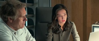 Movie still from “The Meg” (2018), directed by Jon Turteltaub – A woman sitting in a chair looking at the camera; Close Up shot, Over the shoulder angle