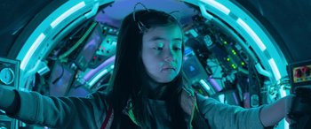 Movie still from “The Meg” (2018), directed by Jon Turteltaub – A young girl in a space suit and some wires on her ears; Close Up shot, Overhead angle