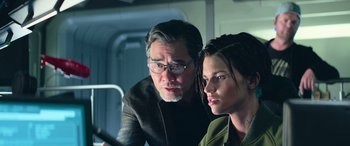 Movie still from “The Meg” (2018), directed by Jon Turteltaub – A man and a woman looking at a computer screen; Close Up shot, Low angle