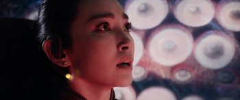 Movie still from “The Meg” (2018), directed by Jon Turteltaub – A woman's face in front of lights; Close Up shot, Low angle