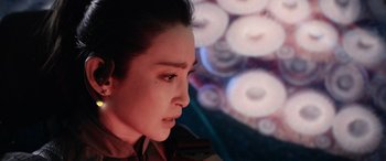 Movie still from “The Meg” (2018), directed by Jon Turteltaub – A woman with a black hair is looking at the camera; Close Up shot, Over the shoulder angle