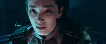 Movie still from “The Meg” (2018), directed by Jon Turteltaub – A person with red eyes looking at the camera; Close Up shot, Overhead angle