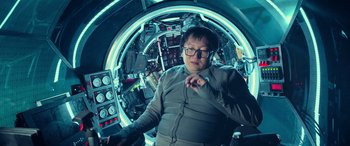 Movie still from “The Meg” (2018), directed by Jon Turteltaub – A man standing inside of a spaceship looking at the camera; Medium shot, Low angle