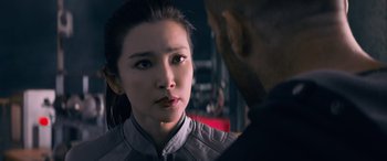 Movie still from “The Meg” (2018), directed by Jon Turteltaub – A young woman is looking at a man in a suit; Close Up shot, Over the shoulder angle