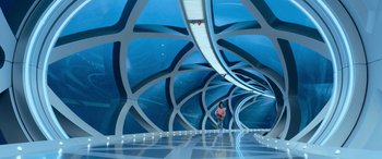 Movie still from “The Meg” (2018), directed by Jon Turteltaub – A woman standing in a room with a blue background; Extreme Wide shot, High angle