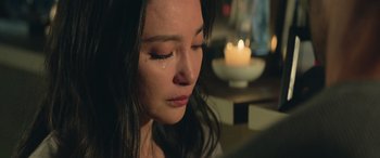 Movie still from “The Meg” (2018), directed by Jon Turteltaub – A person with a candle in the background; Close Up shot, Over the shoulder angle