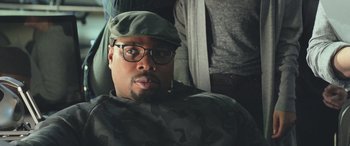 Movie still from “The Meg” (2018), directed by Jon Turteltaub – A person wearing glasses and a hat; Close Up shot, Over the shoulder angle