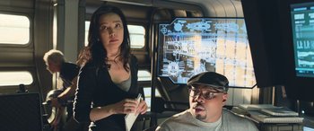 Movie still from “The Meg” (2018), directed by Jon Turteltaub – A man and a woman in front of a computer screen; Medium shot, Over the shoulder angle