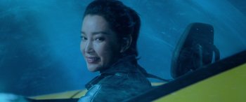 Movie still from “The Meg” (2018), directed by Jon Turteltaub – A woman smiles while sitting in a car; Close Up shot, Over the shoulder angle