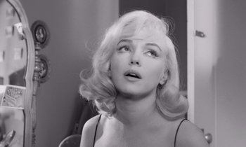 Movie still from “The Misfits” (1961), directed by John Huston – A black - and - white photo of a woman with blonde hair; Close Up shot, Over the shoulder angle