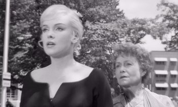 Movie still from “The Misfits” (1961), directed by John Huston – An older woman and a younger woman standing next to each other in front of a tree; Medium shot, Low angle