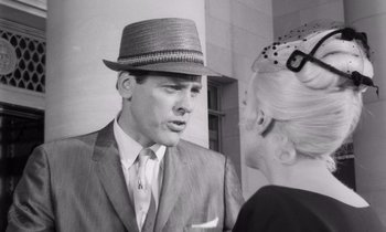 Movie still from “The Misfits” (1961), directed by John Huston – A black and white photo of a man wearing a suit and a hat; Close Up shot, Low angle