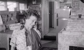 Movie still from “The Misfits” (1961), directed by John Huston – An old photo of an older woman talking on the phone; Medium shot, Low angle