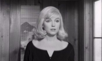 Movie still from “The Misfits” (1961), directed by John Huston – A black and white photo of a woman with blonde hair; Close Up shot, Over the shoulder angle