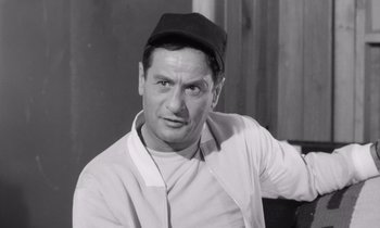 Movie still from “The Misfits” (1961), directed by John Huston – An old black and white photo of a man wearing a baseball cap; Close Up shot, Low angle