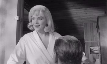 Movie still from “The Misfits” (1961), directed by John Huston – A black and white photo of a woman in a bathrobe; Medium shot, Over the shoulder angle