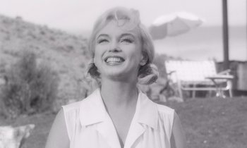 Movie still from “The Misfits” (1961), directed by John Huston – A black - and - white photo of a woman smiling for the camera; Close Up shot, Low angle