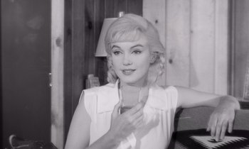 Movie still from “The Misfits” (1961), directed by John Huston – A black - and - white photo of a woman holding a cell phone; Close Up shot, Low angle