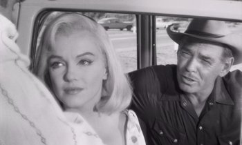 Movie still from “The Misfits” (1961), directed by John Huston – A man and a woman sitting in the back of a car; Close Up shot, Over the shoulder angle