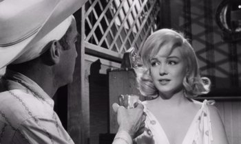 Movie still from “The Misfits” (1961), directed by John Huston – A black - and - white photo of a man and a woman; Medium shot, Low angle