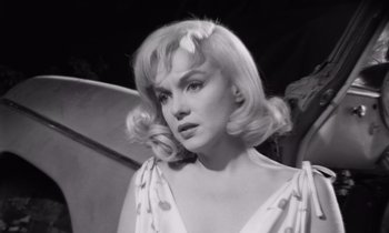 Movie still from “The Misfits” (1961), directed by John Huston – A black and white photo of a woman with blonde hair; Close Up shot, Low angle