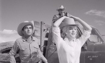 Movie still from “The Misfits” (1961), directed by John Huston – A man and a woman wearing cowboy hats; Medium shot, Low angle