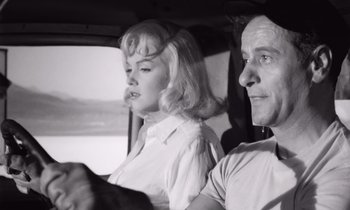 Movie still from “The Misfits” (1961), directed by John Huston – A man and a woman sitting in a car; Close Up shot, Low angle