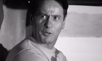 Movie still from “The Misfits” (1961), directed by John Huston – Black and white photograph of a man with a hat on; Close Up shot, Low angle