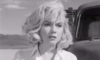 Movie still from “The Misfits” (1961), directed by John Huston – A black and white photo of a woman with blonde hair; Close Up shot, Low angle