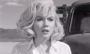 Movie still from “The Misfits” (1961), directed by John Huston – A black - and - white photo of a woman with blonde hair; Close Up shot, Over the shoulder angle