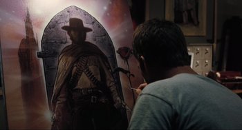 Movie still from “The Mist” (2007), directed by Frank Darabont – A man is painting a picture of a cowboy; Medium shot, Over the shoulder angle