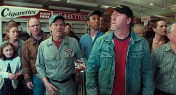 Movie still from “The Mist” (2007), directed by Frank Darabont – A group of men standing next to each other in a store; Medium shot, Over the shoulder angle