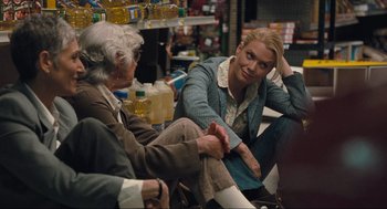 Movie still from “The Mist” (2007), directed by Frank Darabont – Two people sitting on the ground talking to each other; Medium shot, Over the shoulder angle