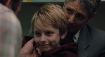 Movie still from “The Mist” (2007), directed by Frank Darabont – An older man is holding a young boy's neck; Close Up shot, Over the shoulder angle