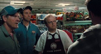 Movie still from “The Mist” (2007), directed by Frank Darabont – Two men standing in front of an aisle in a grocery store; Medium shot, Over the shoulder angle