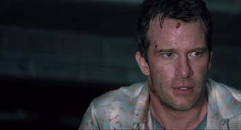 Movie still from “The Mist” (2007), directed by Frank Darabont – A person with blood on his face; Close Up shot, Over the shoulder angle