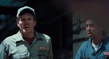 Movie still from “The Mist” (2007), directed by Frank Darabont – A man wearing a green hat and a blue shirt; Close Up shot, Over the shoulder angle