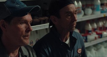Movie still from “The Mist” (2007), directed by Frank Darabont – Two men are standing next to each other; Close Up shot, Over the shoulder angle