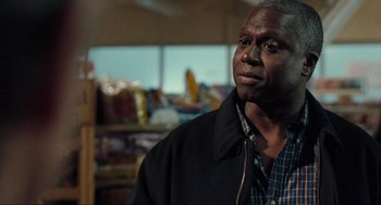 Movie still from “The Mist” (2007), directed by Frank Darabont – A person wearing a jacket in a room; Close Up shot, Over the shoulder angle